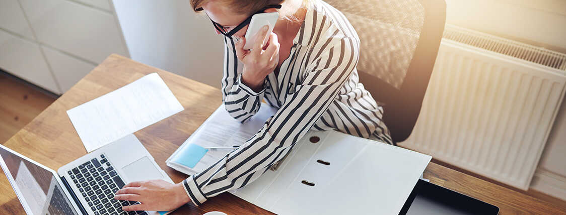 Woman running her business sitting at a laptop computer