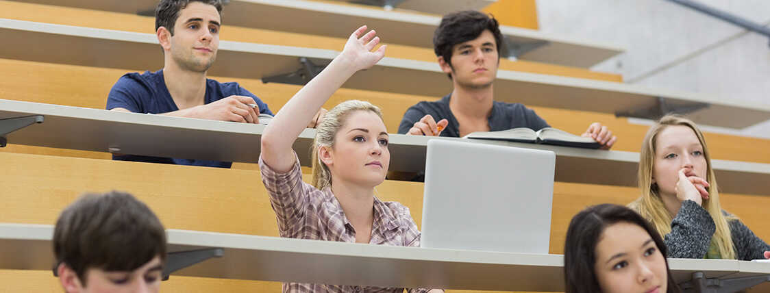 college student raising her hand to ask questions about the SIE exam