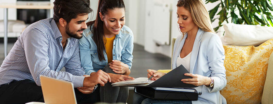 Female insurance agent explaining policy to clients