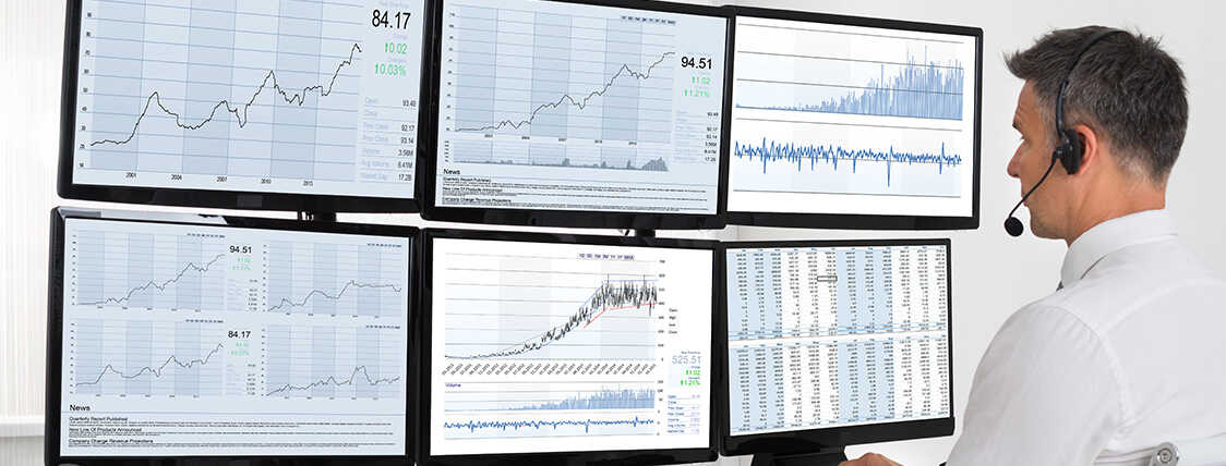 Series 7 license holder analyzing investment performance on 6 computer monitors