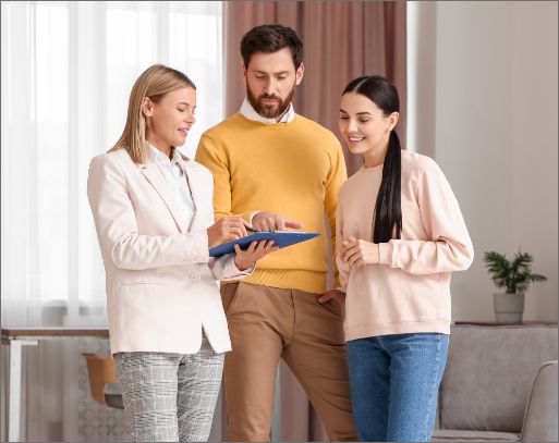 real estate agent showing a couple a house