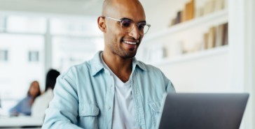 man on laptop at table